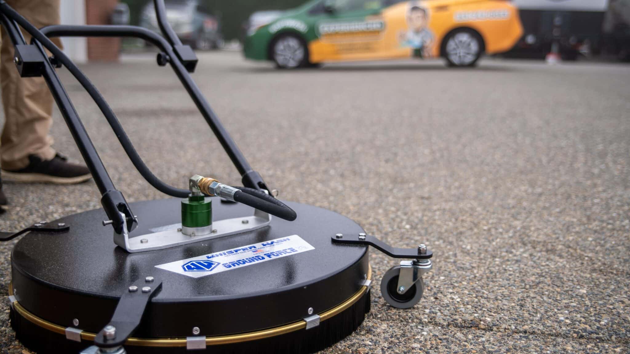 A person doing pressure washing in a drive way