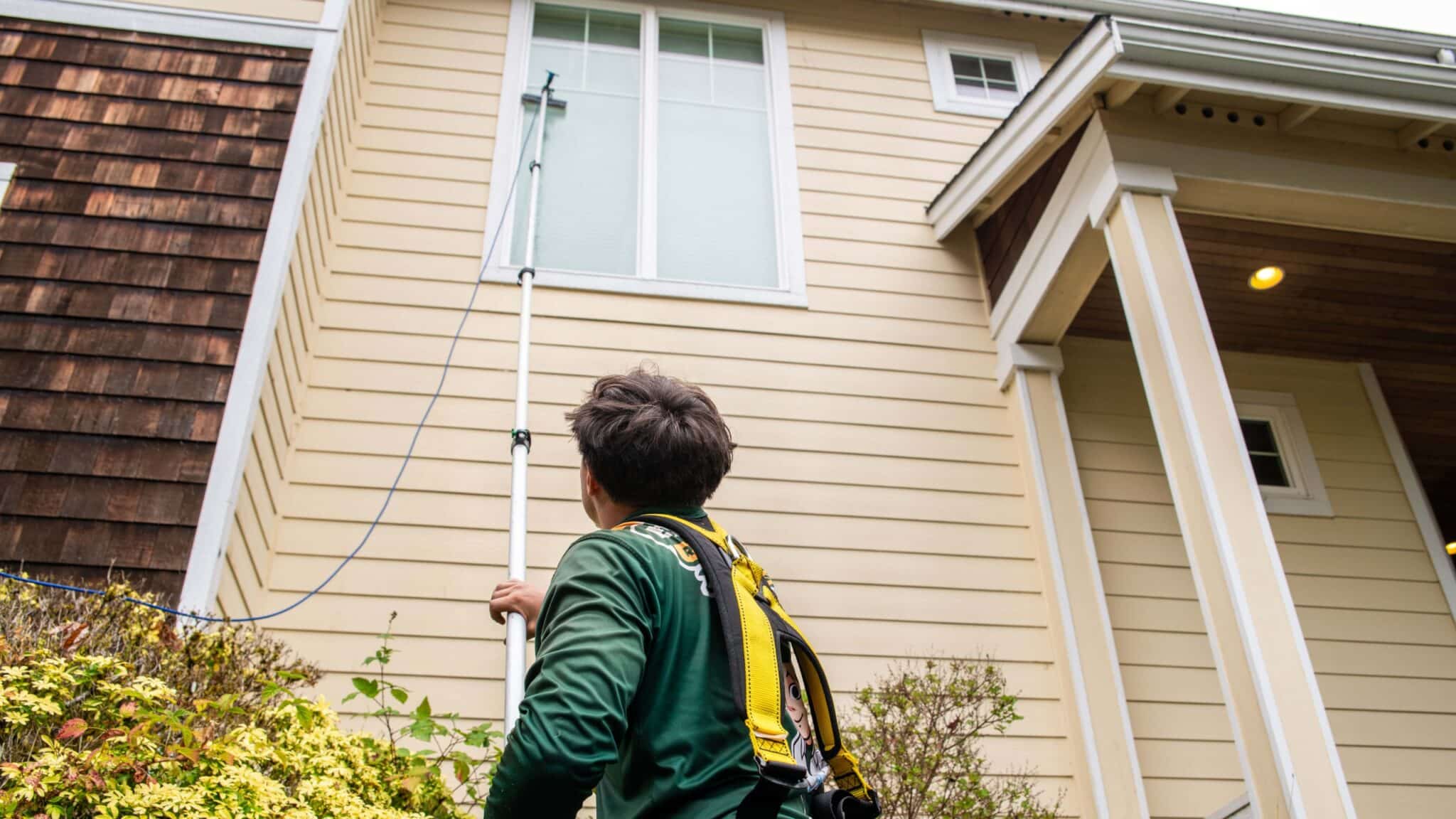 a close up look of a guy doing external window house washing