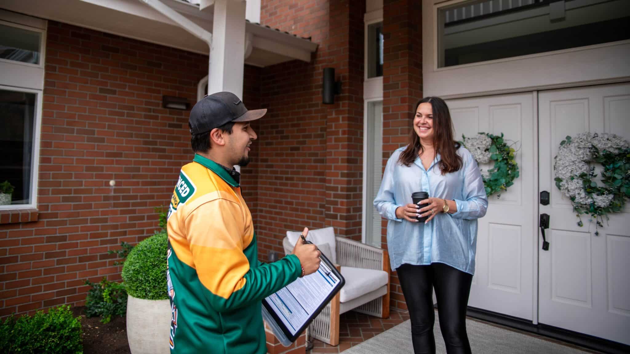 Trusted roofer consulting with customer about roof replacement options.